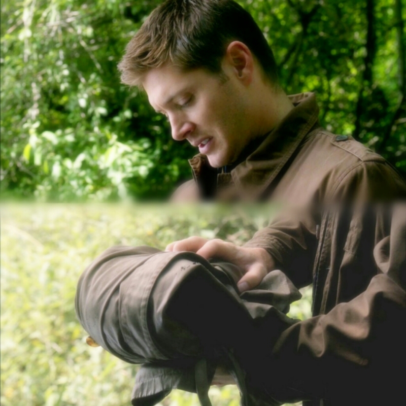 Dean holding Castiel's trench coat ..